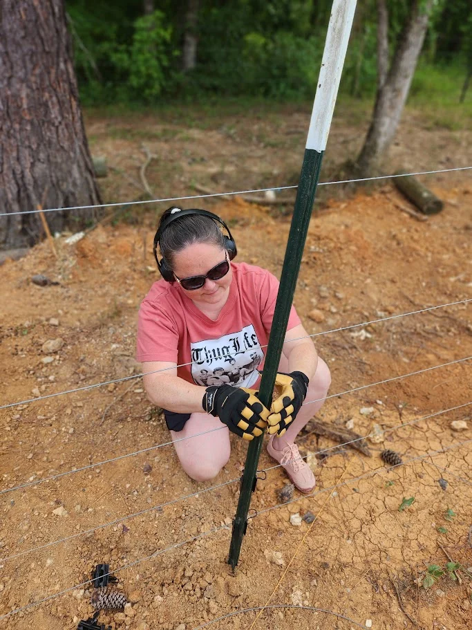 Working on a wire fence in the sunshine